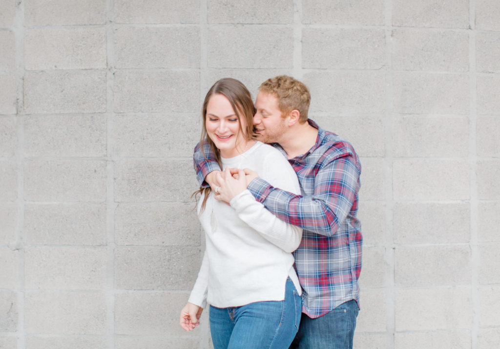 cute couple during rainy engagement session downtown