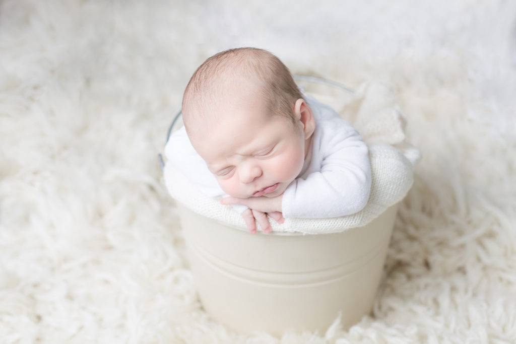 newborn baby photo of baby in a bucket white and organic wool