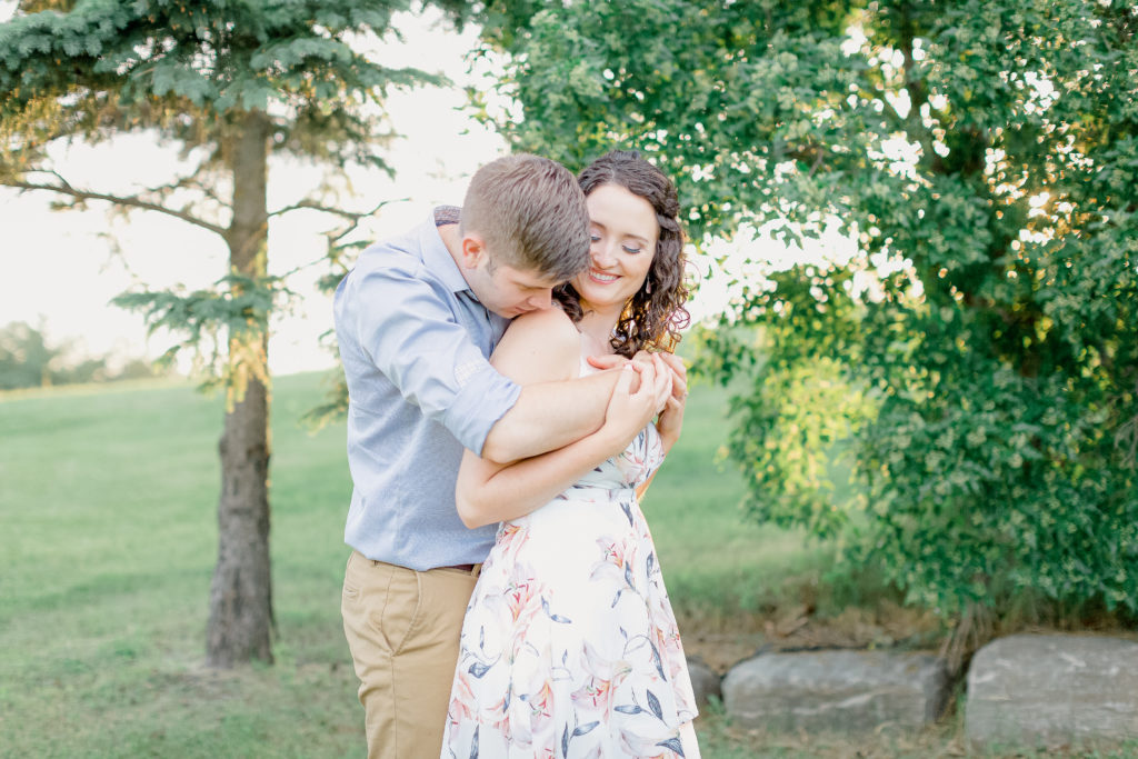 walter baker park engagement session white flower dress with blue dress shirt and beige chinos during sunset kanata recreation centre photos kanata photographer stittsville wedding photographer carp wedding photographer nepean photographer ottawa wedding photographer videographer beautiful light and airy true to colour photos timeless beautiful photos