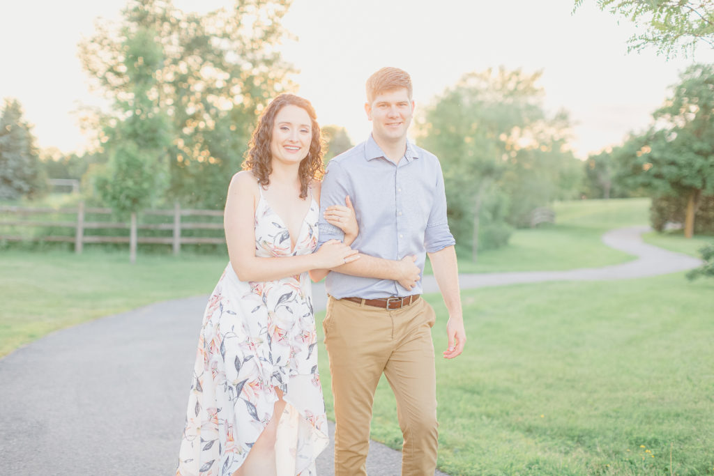 walter baker park engagement session white flower dress with blue dress shirt and beige chinos during sunset kanata recreation centre photos kanata photographer stittsville wedding photographer carp wedding photographer nepean photographer ottawa wedding photographer videographer beautiful light and airy true to colour photos timeless beautiful photos