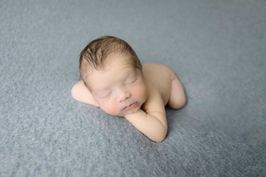newborn baby boy posed in a professional photo studio in ottawa carp grey loft studio photographer cute family session newborn photographer ottawa