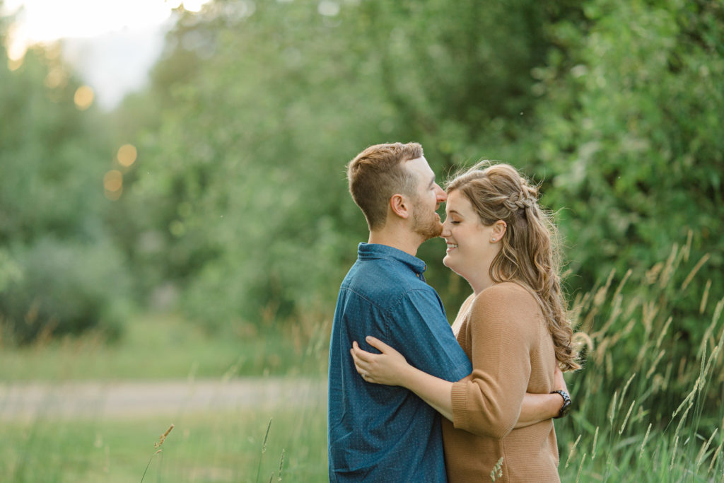 Poses during Engagement Session  Sunset - Natural Posing for Photo Session - Couples Photo Session Fun - Fun on the Farm - Farm Engagement Session - Blue and Brown Engagement Session Inspiration - Natural Engagement Session Posing - Ideas for what to wear for Engagement Photography, Modern Engagement Session Inspiration Wardrobe Ideas. Unsure of what to wear for your engagement photos, we've got you! Romantic brown with black leggings for Summer Engagement in Almonte. Grey Loft Studio is Ottawa's Wedding and Engagement Photographer for Real couples, showcasing photos that are modern, bright, and fun.