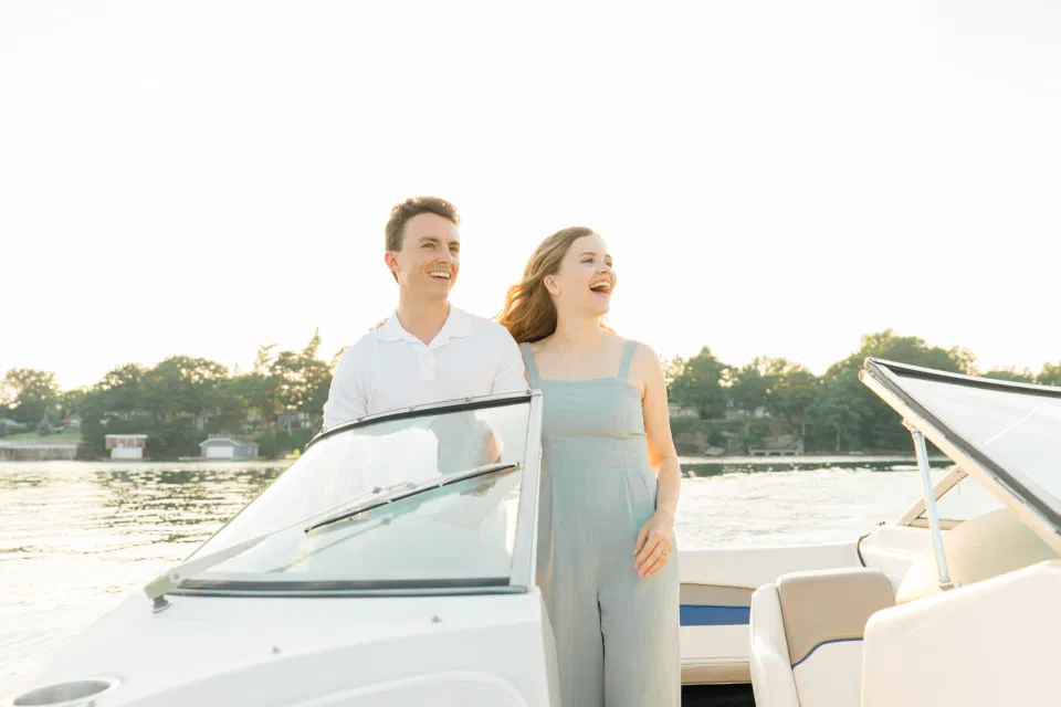 Boat Rides - Ideas for what to wear for Engagement Photography, Modern Engagement Session Inspiration Wardrobe Ideas. Unsure of what to wear for your engagement photos, we've got you! Romantic blue Romper and neutral Shirts and polo. Boat Shoes and Flip Flops. Engagement in Gananoque. Grey Loft Studio is Ottawa's Wedding and Engagement Photographer Videographer for Real couples, showcasing photos that are modern, bright, and fun.