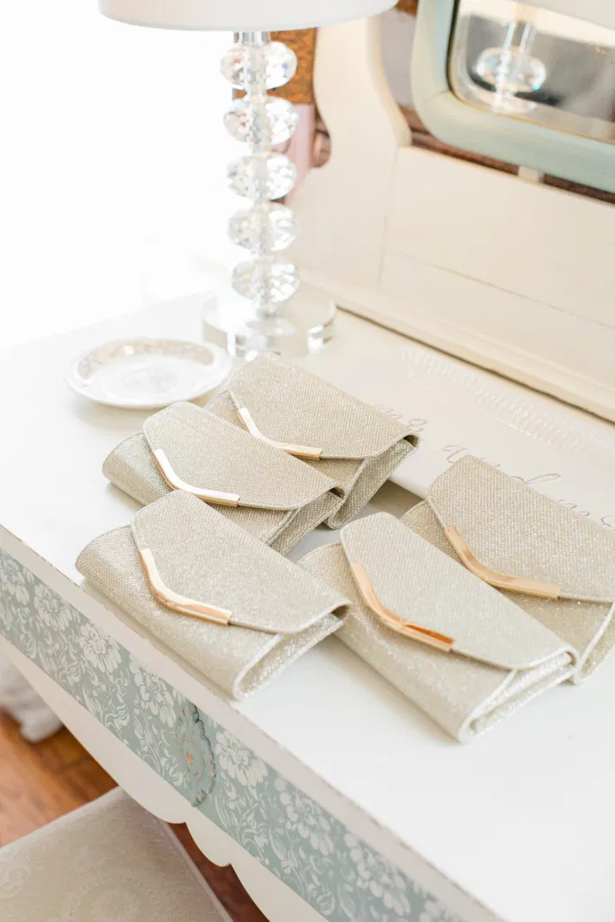Matching Silver Clutches for Bridesmaids - Getting Ready Space - Stonefields Estate-  Bright and Airy -  Natural Wedding Posing - Ideas for what to wear for Blush Wedding Photography, Modern Wedding Blush &. Navy Wardrobe inspiration- Unsure of what to wear for your wedding, we've got you! Romantic white with greenery, blush and navy theme. Grey Loft Studio is Stonefields Wedding and Engagement Photographer for Real couples, showcasing photos that are modern, bright, and fun.