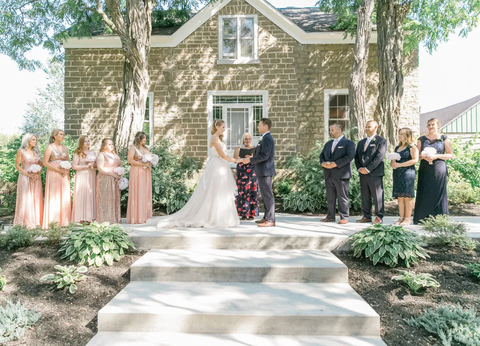 Bride and Groom Holding Hands During Wedding Ceremony -  Stonefields Estate-  Bright and Airy - Natural Wedding Posing - Modern Wedding Blush &. Navy Wardrobe inspiration-  Romantic white with greenery, blush and navy theme. Grey Loft Studio is Stonefields Wedding and Engagement Photographer for Real couples, showcasing photos that are modern, bright, and fun.