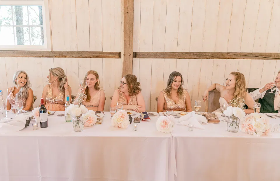 Bridal Party Head Table - Fun shots with Bridesmaids - Rose Gold Sequinned Dresses -  Stonefields Estate-  Bright and Airy - Natural Wedding Posing - Modern Wedding Blush &. Navy Wardrobe inspiration-  Romantic white with greenery, blush and navy theme. Grey Loft Studio is Stonefields Wedding and Engagement Photographer for Real couples, showcasing photos that are modern, bright, and fun.