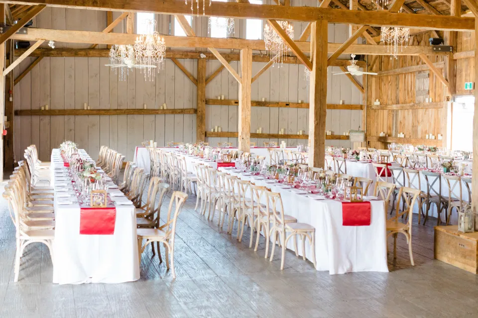 Indoor Heritage Barn at Evermore Wedding's and Events - Almonte - Hanging Chandeliers, Rustic Modern Chairs, White linens. Ruby Red Lovely Wedding at Evermore. 
