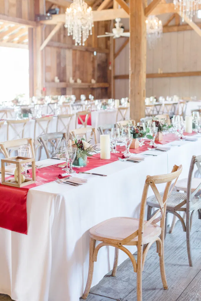 Indoor Heritage Barn at Evermore Wedding's and Events - Almonte - Hanging Chandeliers, Rustic Modern Chairs, White linens. Ruby Red Lovely Wedding at Evermore. 