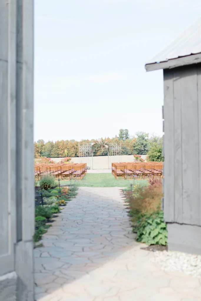 Outdoor Ceremony With Wooden Modern Brown Wood Chairs. Interlock, beautiful Landscapes at Evermore Weddings and Events, Almonte Ontario - Grey Loft Studio