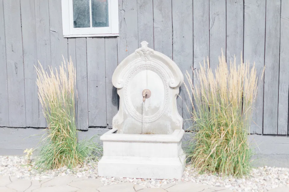 Modern Outdoor Fountain - Outdoor Ceremony With Wooden Modern Brown Wood Chairs. Interlock, beautiful Landscapes at Evermore Weddings and Events, Almonte Ontario - Grey Loft Studio