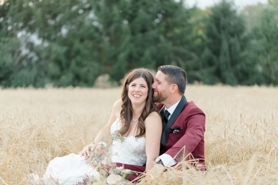 Sitting in a Wheat Field - Holding Hands - Bride and Groom Posing at Sunset - Evermore Wedding and Events, Almonte - Bright, Modern, and Fun Wedding Photography. Grey Loft Studio . Wedding Photographer Ottawa. 