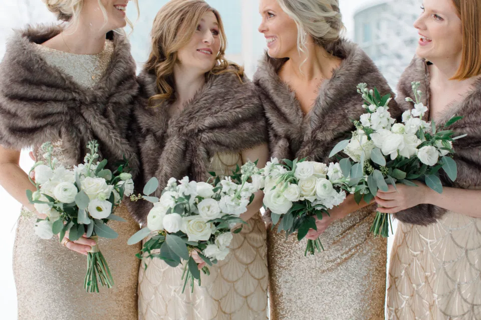 Brown Fur, Gold Mix Bridesmaid Dresses, Beautiful White and Greenery Mixed Bouquets. NYE Wedding - NYE Wedding - Natural Wedding Posing - Ideas for what to wear for Wedding on NYE Photography, Modern Wedding NYE Wardrobe inspiration- Must Have photo at Midnight -  Unsure of what to wear for your wedding, we've got you! Romantic white with greenery theme. Lace Wedding Dress in Ottawa. Grey Loft Studio is Ottawa's Wedding and Engagement Photographer for Real couples, showcasing photos that are modern, bright, and fun.