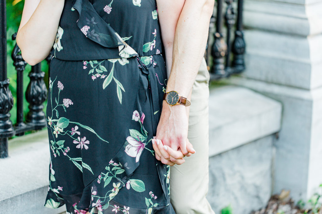 Holding Hands Shot - Engagement Photo Poses- Posing while at Rideau Hall - Ideas for what to wear for Engagement Photography, Modern Engagement Session Inspiration Wardrobe Ideas. Unsure of what to wear for your engagement photos, we've got you! Romantic floral dress. Black Polo T-shirt & neutral pants . Boat Shoes and Fancy beaded wedges. Engagement downtown Ottawa. Grey Loft Studio is Ottawa's Wedding and Engagement Photographer Videographer for Real couples, showcasing photos that are modern, bright, and fun.