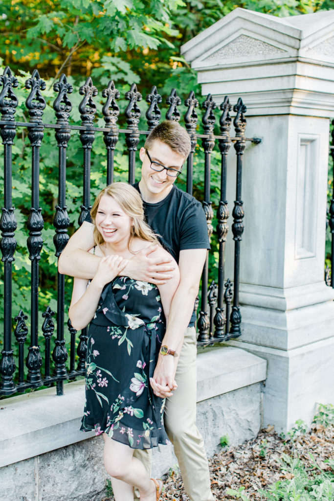 Cute Posing for Tall guys with short girls - Holding Hands Shot - Engagement Photo Poses- Posing while at Rideau Hall - Ideas for what to wear for Engagement Photography, Modern Engagement Session Inspiration Wardrobe Ideas. Unsure of what to wear for your engagement photos, we've got you! Romantic floral dress. Black Polo T-shirt & neutral pants . Boat Shoes and Fancy beaded wedges. Engagement downtown Ottawa. Grey Loft Studio is Ottawa's Wedding and Engagement Photographer Videographer for Real couples, showcasing photos that are modern, bright, and fun.
