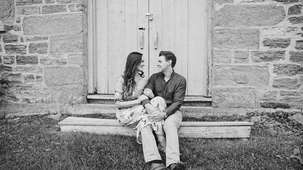 Couple posing in Black and White-Ideas for what to wear for Engagement Photography, Modern Engagement Session Inspiration Wardrobe Ideas. Unsure of what to wear for your engagement photos, we've got you! Romantic white with Pink Flower dress for Summer Engagement in Ottawa. Grey Loft Studio is Ottawa's Wedding and Engagement Photographer for Real couples, showcasing photos that are modern, bright, and fun.