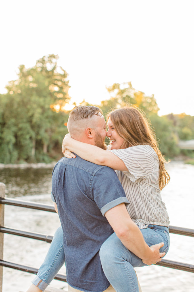 The Butt Grab & Lift - Watson's Mill Engagement Session Manotick - Bright & Airy photography - Grey Loft Studio - Ottawa Wedding Photographer - Ottawa Wedding Videographer - Engagement Session Locations in Ottawa - Summer Engagement session - Light blue and Cream with casual jeans and strap sandals. Ottawa Photo Studio.