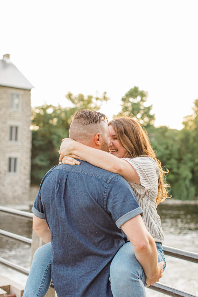 Couple posing during engagement session - Watson's Mill Engagement Session Manotick - Bright & Airy photography - Grey Loft Studio - Ottawa Wedding Photographer - Ottawa Wedding Videographer - Engagement Session Locations in Ottawa - Summer Engagement session - Light blue and Cream with casual jeans and strap sandals. Ottawa Photo Studio.