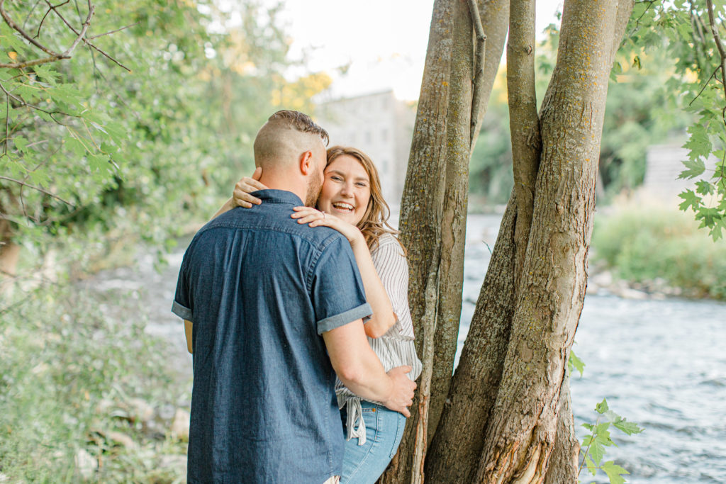 Laugh full of love- engagement session - Watson's Mill Engagement Session Manotick - Bright & Airy photography - Grey Loft Studio - Ottawa Wedding Photographer - Ottawa Wedding Videographer - Engagement Session Locations in Ottawa - Summer Engagement session - Light blue and Cream with casual jeans and strap sandals. Ottawa Photo Studio.