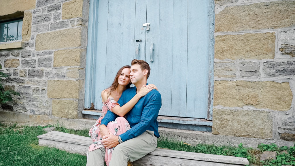 Romantic Pose -Ideas for what to wear for Engagement Photography, Modern Engagement Session Inspiration Wardrobe Ideas. Unsure of what to wear for your engagement photos, we've got you! Romantic white with Pink Flower dress for Summer Engagement in Ottawa. Grey Loft Studio is Ottawa's Wedding and Engagement Photographer for Real couples, showcasing photos that are modern, bright, and fun. Pinhey's Point Dunrobin.